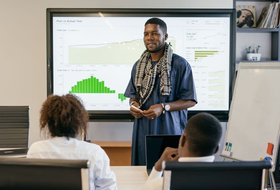 A leader presenting campaign performance to a boardroom